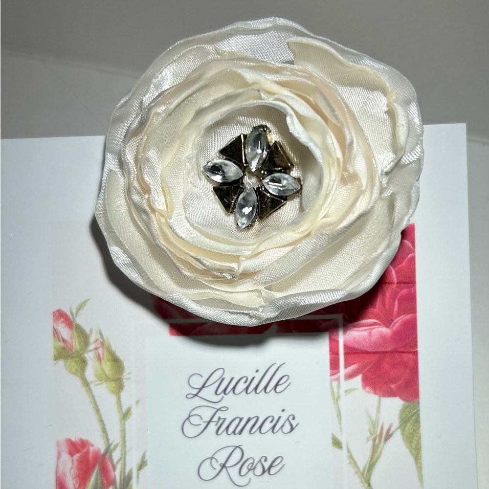 White satin handmade hair flower on alligator clip. Removable feathers